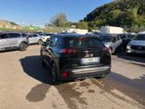 a black car parked in a parking lot next to other cars