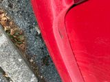 a red car that is parked on the side of the street