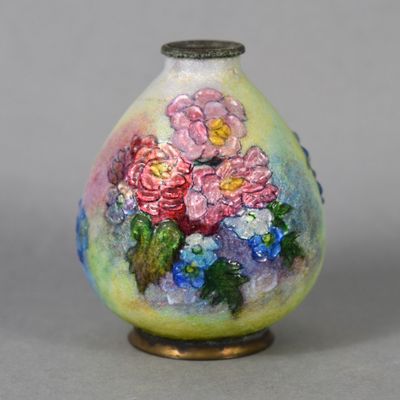 a vase with flowers painted on it sitting on a table