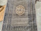 a rug that is laying on the floor next to a bag