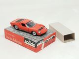 a red toy car sitting on top of a box