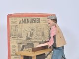 a small doll that is standing in front of a table