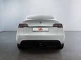 the rear end of a white car in a white room
