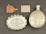 several items including a bottle, a bottle opener, and a plaque