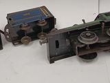 four toy trains that are sitting on a white surface