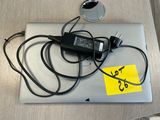 a laptop that has a charger on it on a table