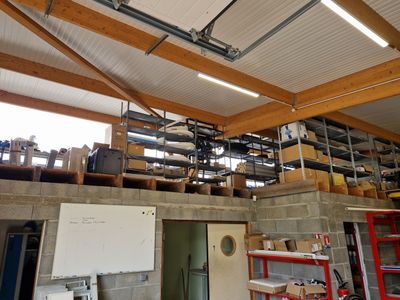 a large room with a lot of shelves and a whiteboard