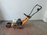 a small lawn mower that is sitting on the floor