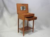 a small wooden table with a mirror on it