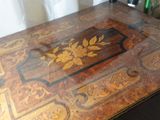 a wooden table with a floral design on it