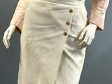 a mannequin wearing a pink shirt and white skirt