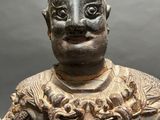 an old statue of a man with a hat on his head