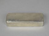 an old silver box with a silver lid sitting on a white surface