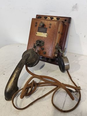 an old fashioned telephone with a cord attached to it