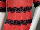 a mannequin wearing a red and black striped dress