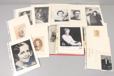 a lot of old photos of people on a table
