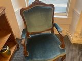 a blue chair in the corner of a room