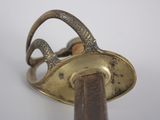 a metal object with a wooden handle on a white surface