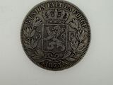 a silver coin with a crown on top of it