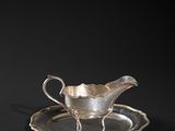 a silver plate with a saucer and saucer on it