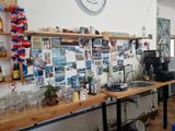 a kitchen with a lot of clutter on the counter