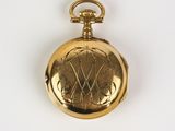 an image of a gold pocket watch on a white surface