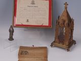 several pieces of art are displayed in a display case on a table