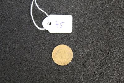 a coin and a price tag on a black surface