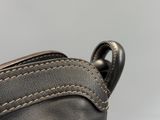 the back of a black leather purse with a zipper on it
