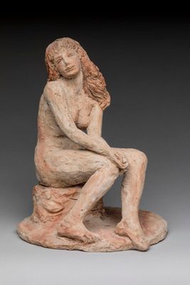 an image of a statue of a woman sitting on a rock
