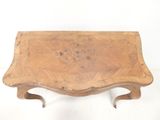 a small wooden table with a wooden top on a white surface