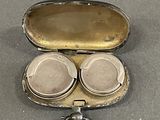 a silver case with a pair of headphones inside of it