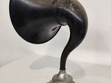 a black and silver lamp that is on a white table