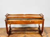 an old wooden bench sitting on top of a hard wood floor