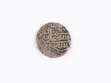 a close up of a coin with arabic writing on it