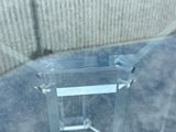 a clear table with a glass top on a sidewalk