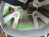 a close up of a metal object with a black ribbon on it