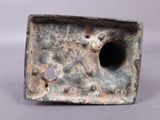 an old metal object with holes in the middle of it