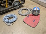 a machine that is sitting on the floor next to some hoses