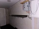 an image of a room with a refrigerator and a shelf