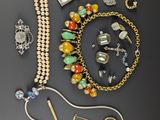 several different jewelry items are laid out on a black surface
