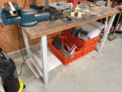 a workbench with tools on it in a garage