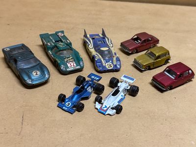 several toy cars are lined up in a row on a table