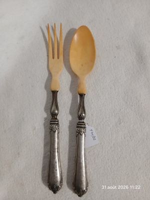 deux cuillères et une fourchette posées sur une nappe blanche