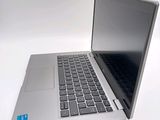 a silver laptop with a black keyboard on a white surface
