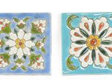 two tiles with flowers on them on a white background