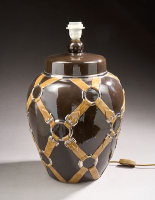 a brown and yellow vase with a light on it