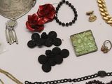many different types of necklaces and bracelets on the table