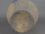 a close up view of a vase with a blue dot on it