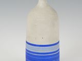a white and blue vase with a blue stripe on it